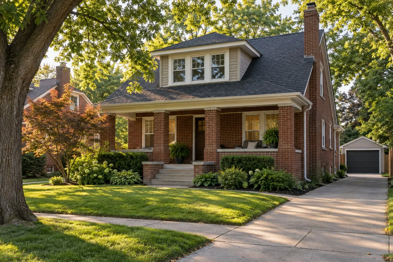 Roof replacement, Royal Oak: brick bungalow with a charcoal shingle roof and a detached garage